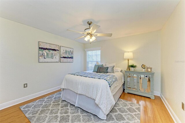 bedroom with ceiling fan and hardwood / wood-style flooring