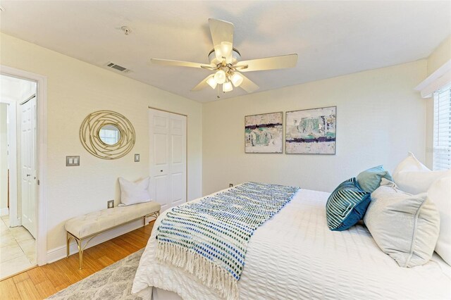 bedroom with a closet, ceiling fan, and hardwood / wood-style floors