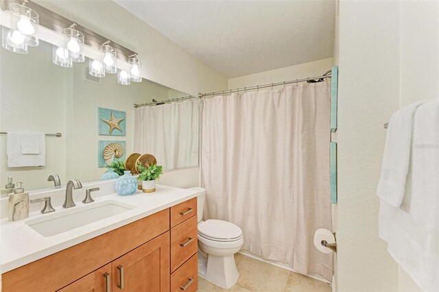 bathroom featuring tile patterned floors, walk in shower, vanity, a textured ceiling, and toilet