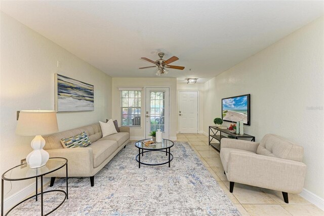 tiled living room with ceiling fan