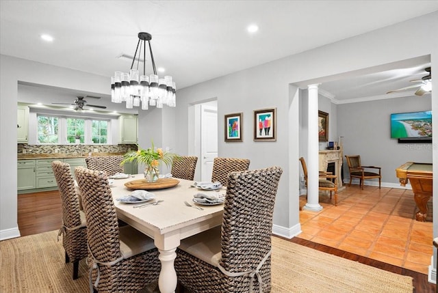 tiled dining room with crown molding, ceiling fan, pool table, and decorative columns