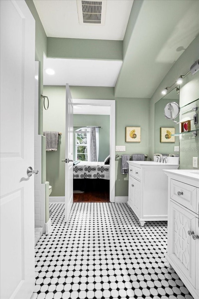 bathroom featuring toilet, tile patterned floors, and vanity