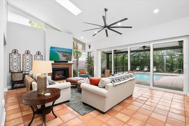 living room with a skylight, light tile patterned floors, and high vaulted ceiling