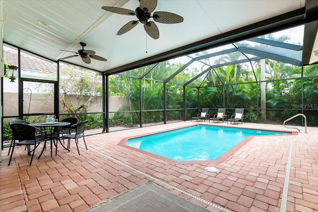 view of swimming pool featuring a patio area, a lanai, and ceiling fan