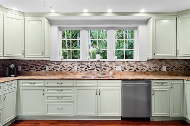 kitchen featuring stainless steel dishwasher, backsplash, sink, and light stone counters