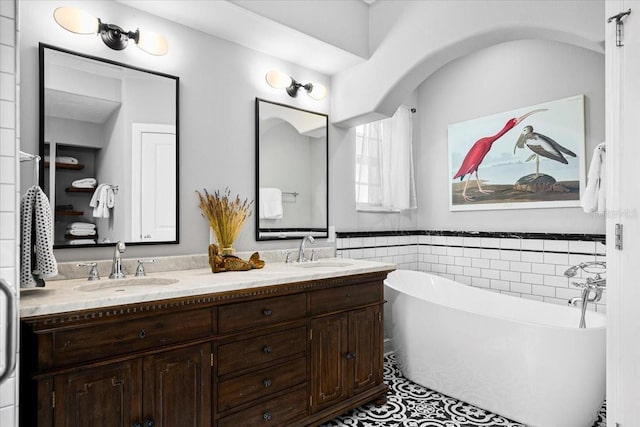 bathroom with a bathing tub and vanity