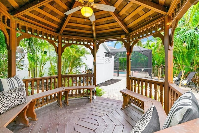 wooden terrace featuring a lanai and a gazebo