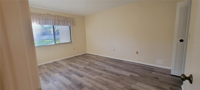 unfurnished bedroom with hardwood / wood-style flooring