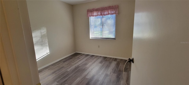 unfurnished room with hardwood / wood-style flooring