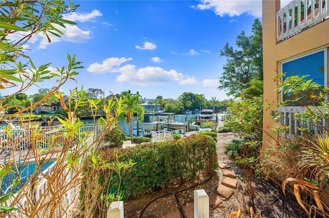 view of yard featuring a boat dock and a water view