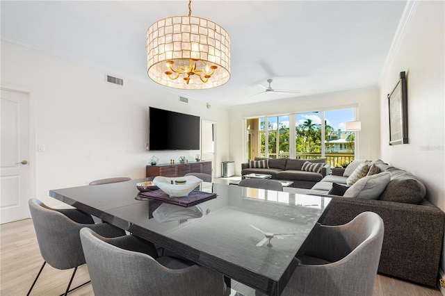 dining area with crown molding, light hardwood / wood-style floors, and ceiling fan with notable chandelier