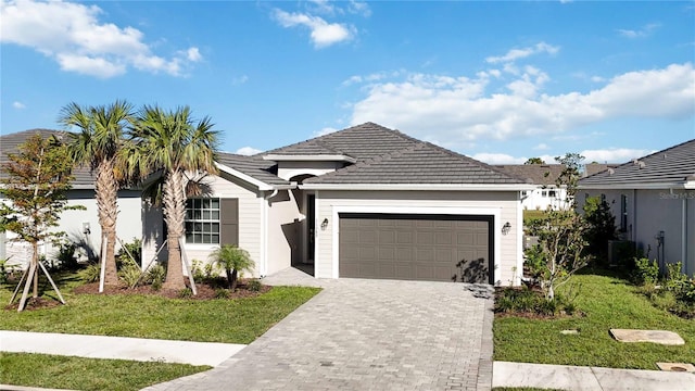 view of front of property with a front yard and a garage