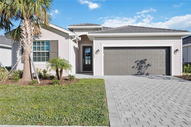 view of front of property with a front yard and a garage