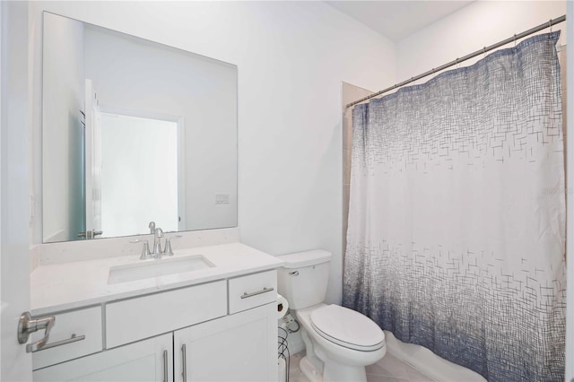 bathroom featuring tile patterned floors, vanity, and toilet