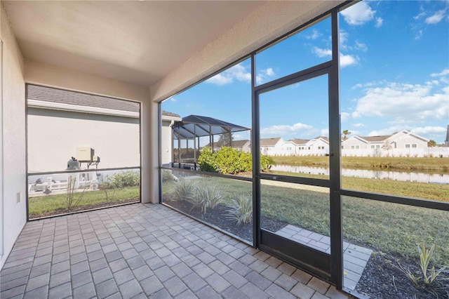 unfurnished sunroom with a water view