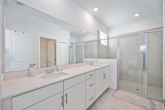 bathroom with vanity and a shower with shower door