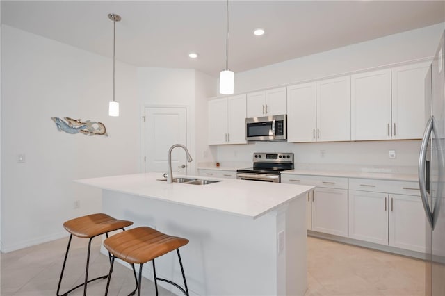 kitchen with white cabinets, pendant lighting, stainless steel appliances, and sink