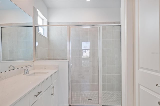 bathroom with vanity and a shower with door