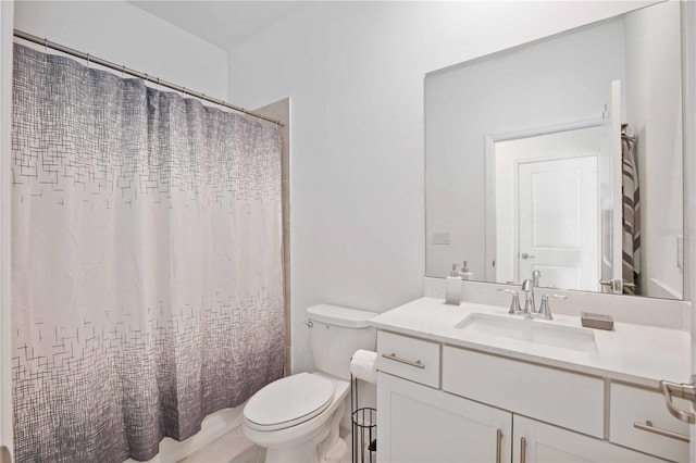 bathroom with vanity, curtained shower, and toilet