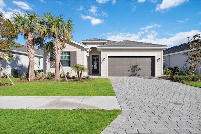 view of front of house featuring a garage and a front lawn