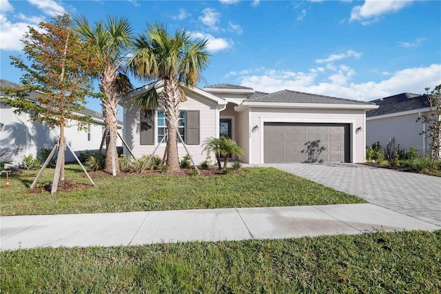 view of front of home with a front yard and a garage