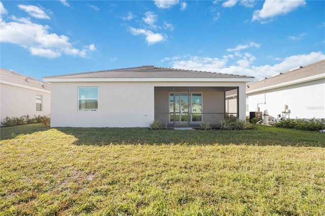 rear view of property with a yard