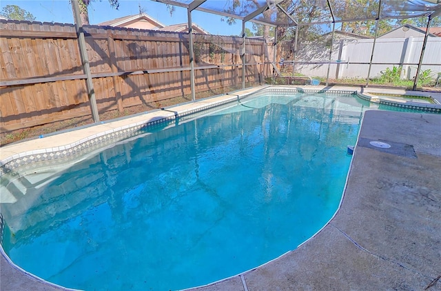 view of pool with glass enclosure