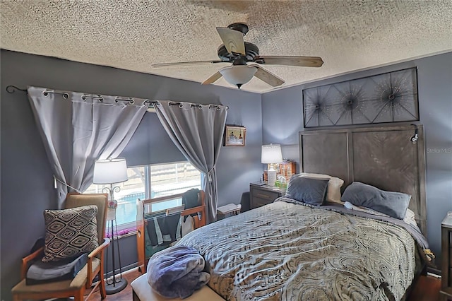 bedroom with a textured ceiling and ceiling fan