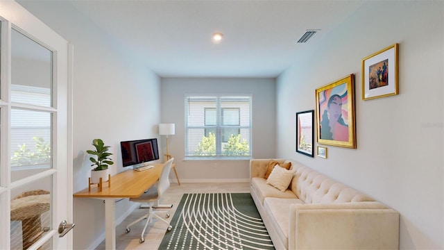 office space with light hardwood / wood-style floors