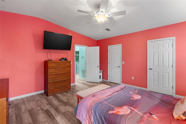 bedroom with hardwood / wood-style flooring, ceiling fan, and lofted ceiling