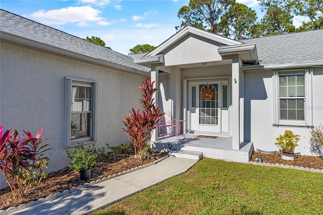 entrance to property with a lawn