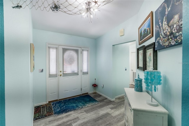 foyer entrance featuring a notable chandelier and light hardwood / wood-style flooring