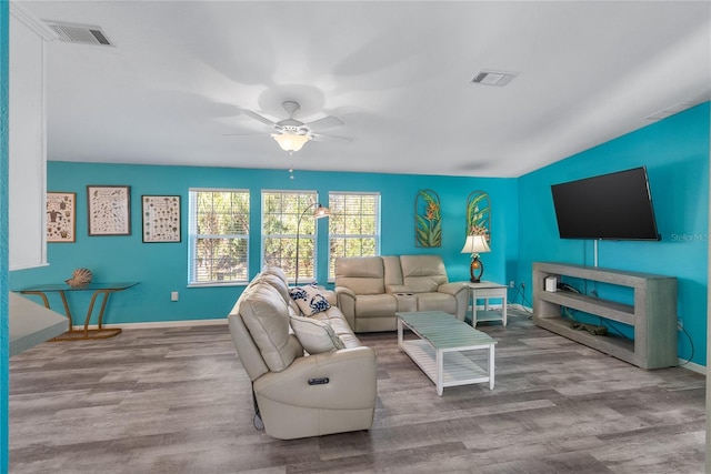 living room featuring light hardwood / wood-style floors and ceiling fan