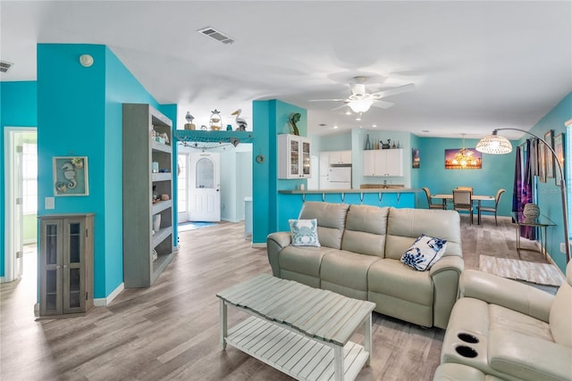 living room featuring ceiling fan and wood-type flooring