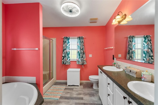 full bathroom with wood-type flooring, vanity, toilet, and independent shower and bath