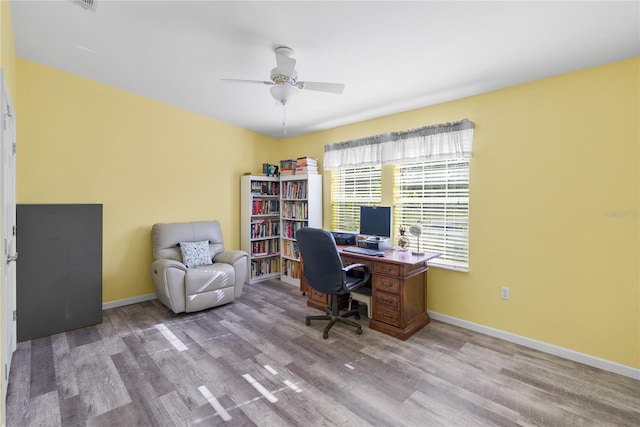 office area with light hardwood / wood-style flooring and ceiling fan