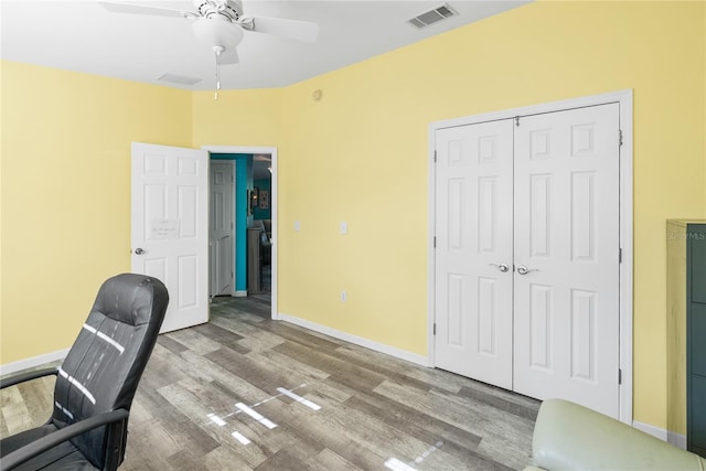 office space with light hardwood / wood-style flooring and ceiling fan