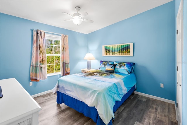 bedroom with ceiling fan and dark wood-type flooring