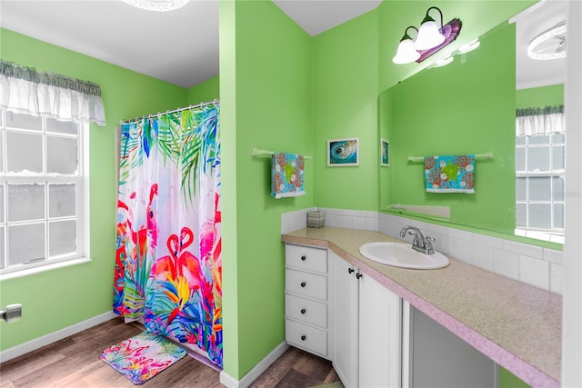 bathroom featuring hardwood / wood-style floors, vanity, and curtained shower