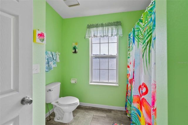 bathroom featuring hardwood / wood-style floors, a healthy amount of sunlight, and toilet