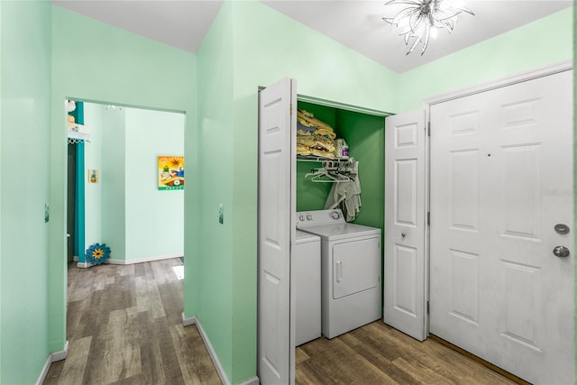 washroom featuring hardwood / wood-style flooring, separate washer and dryer, and a chandelier