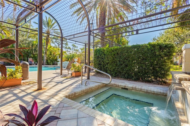 view of pool featuring an in ground hot tub and a patio area