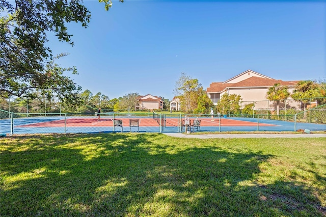 view of basketball court with a lawn