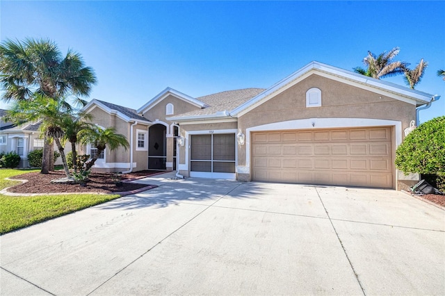 ranch-style home with a garage, driveway, and stucco siding