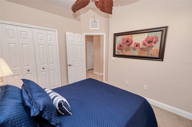 bedroom with light colored carpet, a closet, and ceiling fan