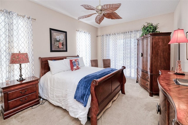 bedroom with ceiling fan and light colored carpet