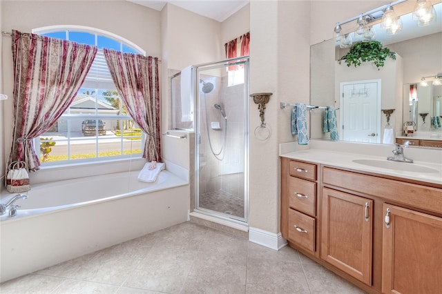 bathroom featuring tile patterned floors, vanity, and shower with separate bathtub