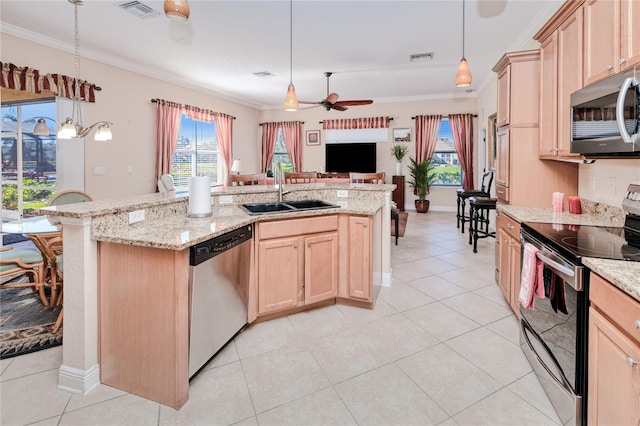 kitchen featuring ceiling fan, sink, pendant lighting, light brown cabinetry, and appliances with stainless steel finishes