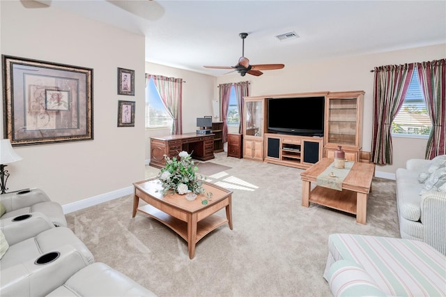 carpeted living room with ceiling fan