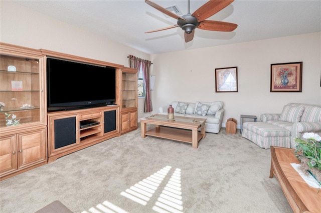 carpeted living room featuring ceiling fan